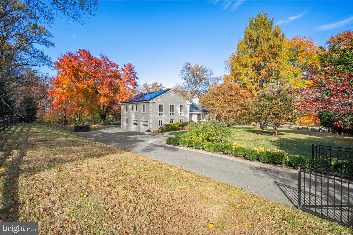 10801 Spring Knoll Drive Potomac, MD 20854 - Photo 4 of 100 a front view of a house with a yard and garage