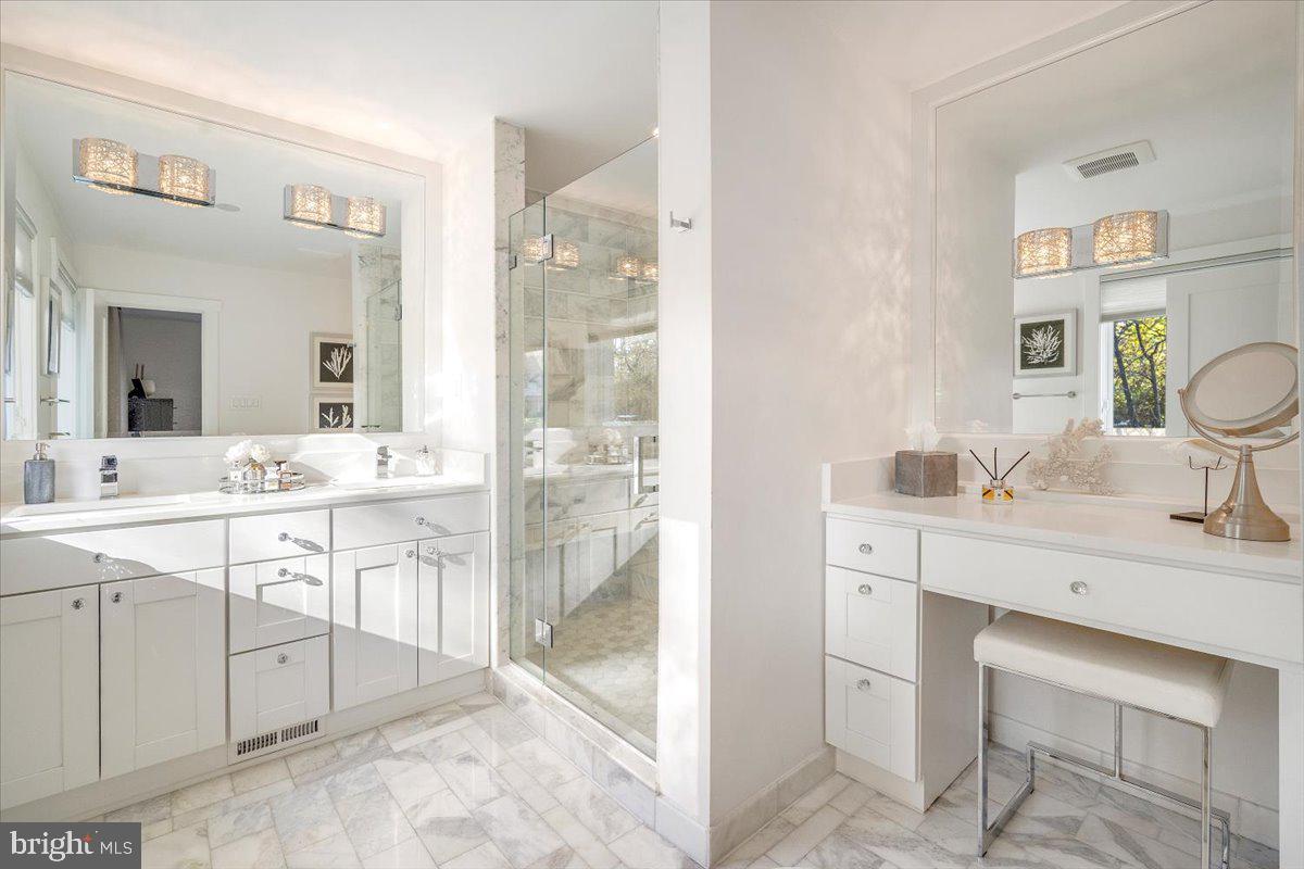 10801 Spring Knoll Drive Potomac, MD 20854 - Photo 49 of 100 a spacious bathroom with a sink double vanity and a mirror