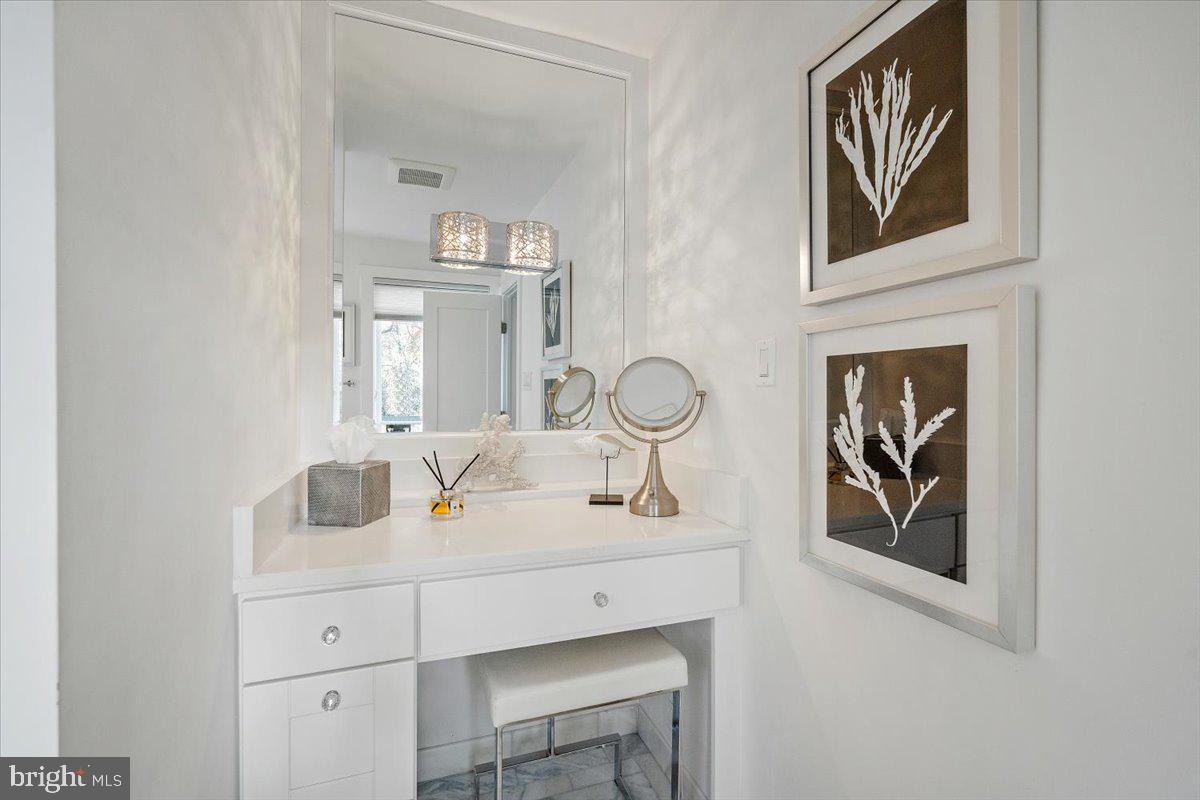 10801 Spring Knoll Drive Potomac, MD 20854 - Photo 53 of 100 a bathroom with a sink and a mirror