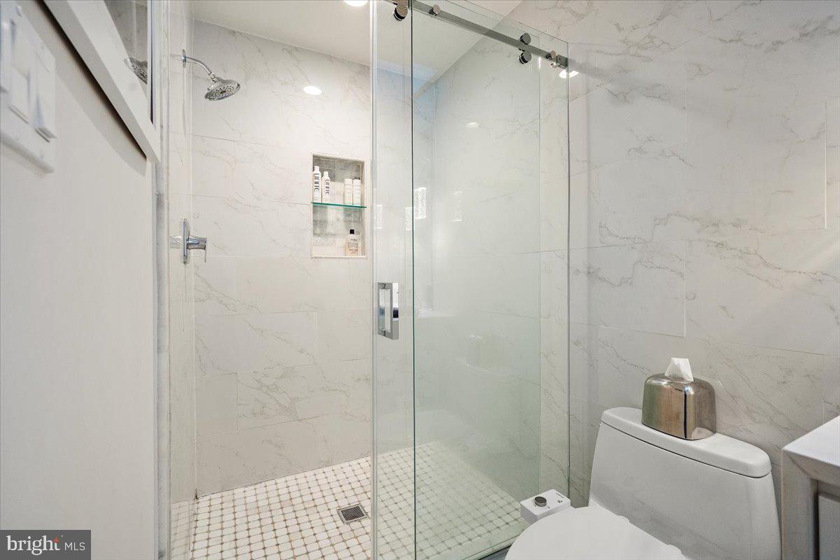 10801 Spring Knoll Drive Potomac, MD 20854 - Photo 57 of 100 a bathroom with a shower a toilet and sink