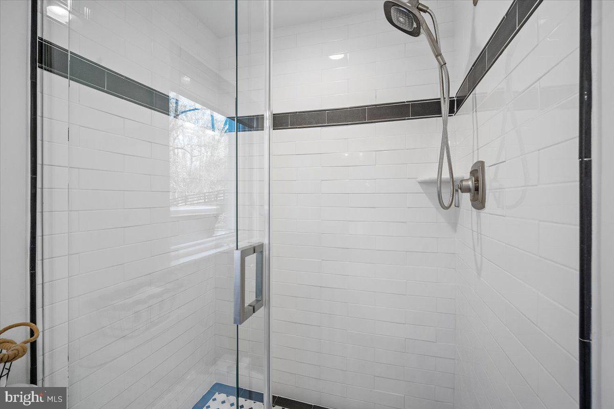 10801 Spring Knoll Drive Potomac, MD 20854 - Photo 61 of 100 a bathroom with a shower and a glass door