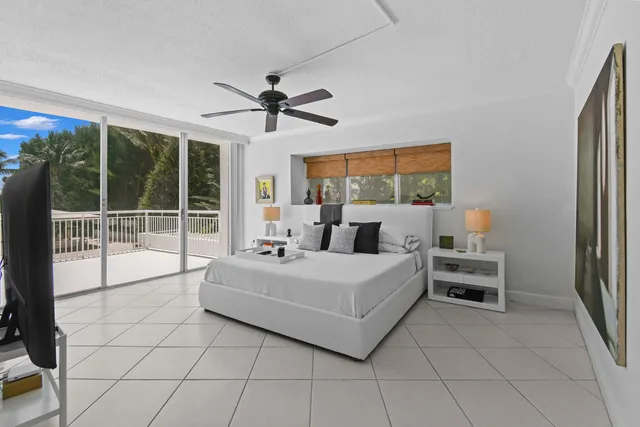 a bed room with a bed and a large window