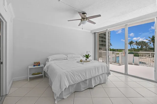 a bedroom with a bed and a view of balcony