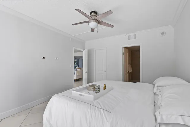 a bedroom with a bed and a ceiling fan