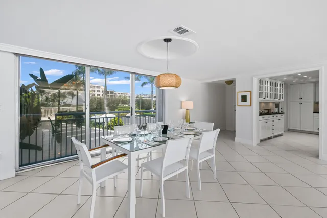 a view of a dining room with furniture wooden floor and chandelier