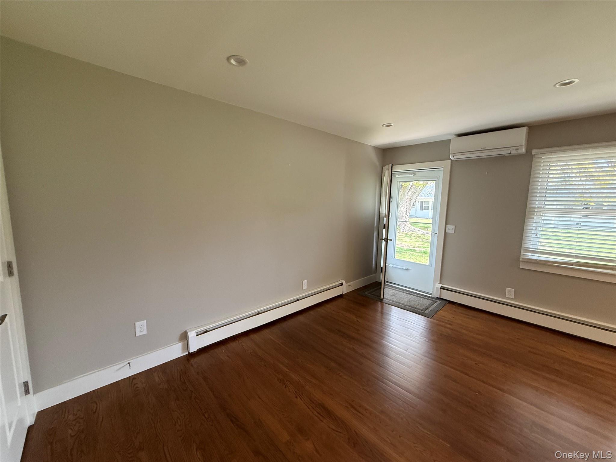 55075 Main Road, Unit YOUNGS BLDG #3 Southold, NY 11971 - Photo 3 of 16 an empty room with wooden floor and windows