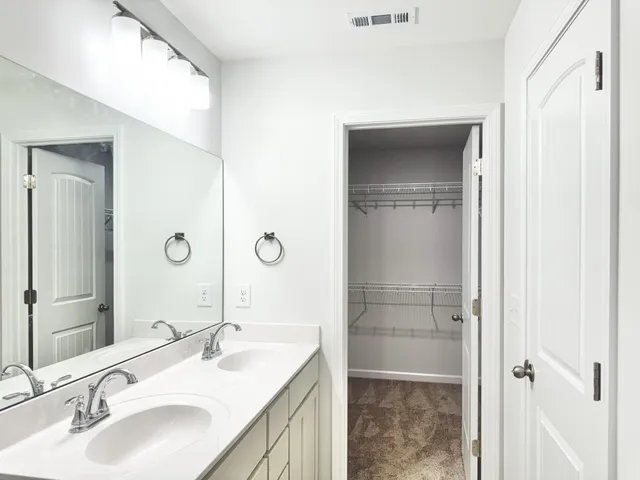 a bathroom with a granite countertop sink shower and a mirror