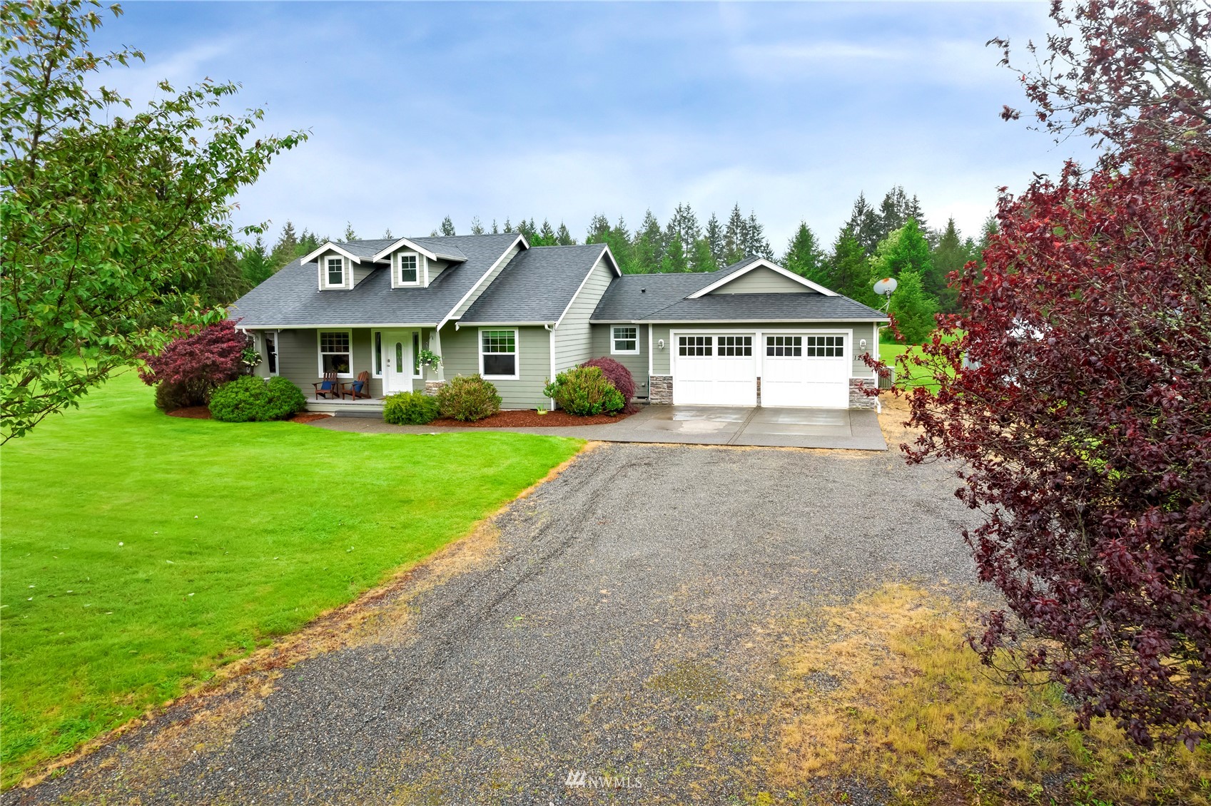 12035 Hunter Loop Road Southwest Rochester, WA 98579 - Photo 1 of 29 a front view of a house with a yard and potted plants