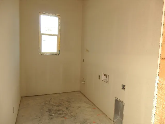 a view of an empty room and a window