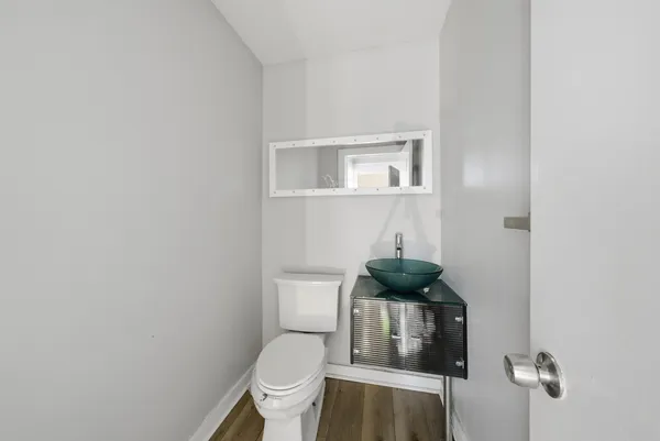 a bathroom with a sink a toilet and a window