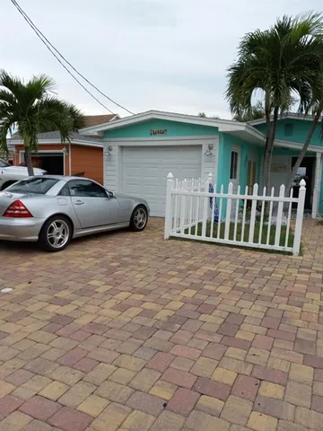 a front view of a house with parking area