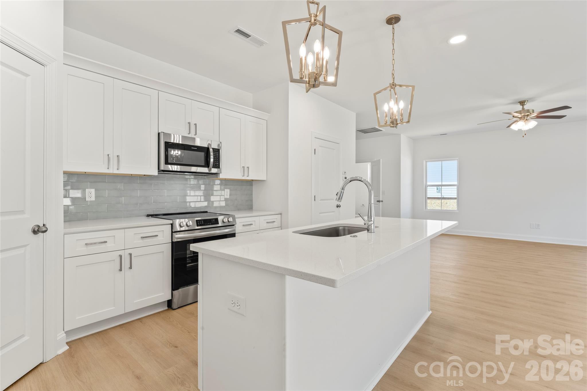 753 Mockingbird Road, Unit 2 Albemarle, NC 28001 - Photo 17 of 36 a kitchen with kitchen island granite countertop appliances cabinets and a counter top space