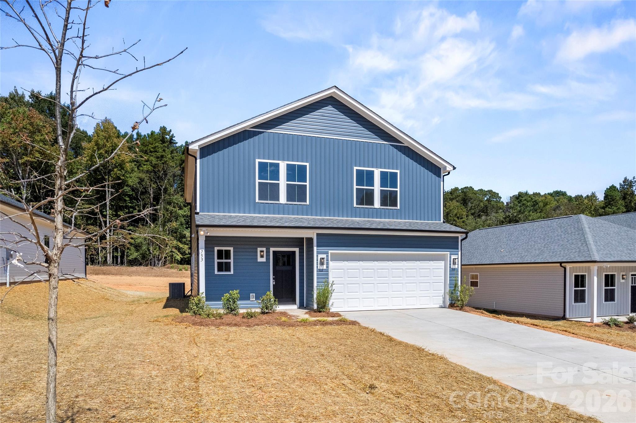 753 Mockingbird Road, Unit 2 Albemarle, NC 28001 - Photo 2 of 36 a front view of a house with a yard and garage