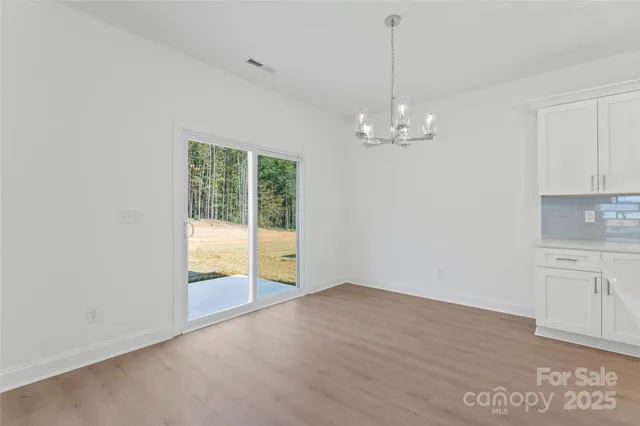 an empty room with window and ceiling fan