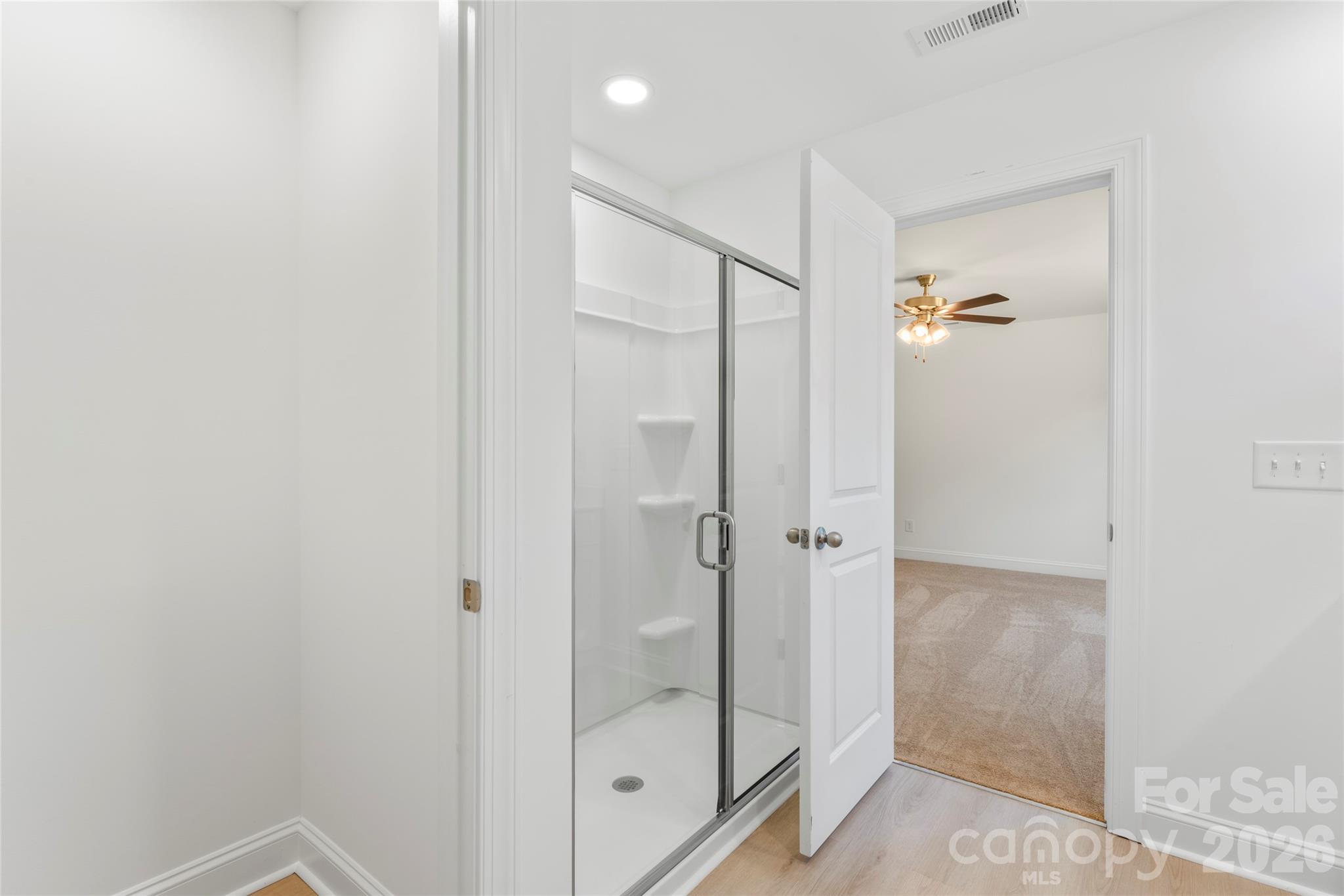 753 Mockingbird Road, Unit 2 Albemarle, NC 28001 - Photo 27 of 36 a bathroom with a glass shower door