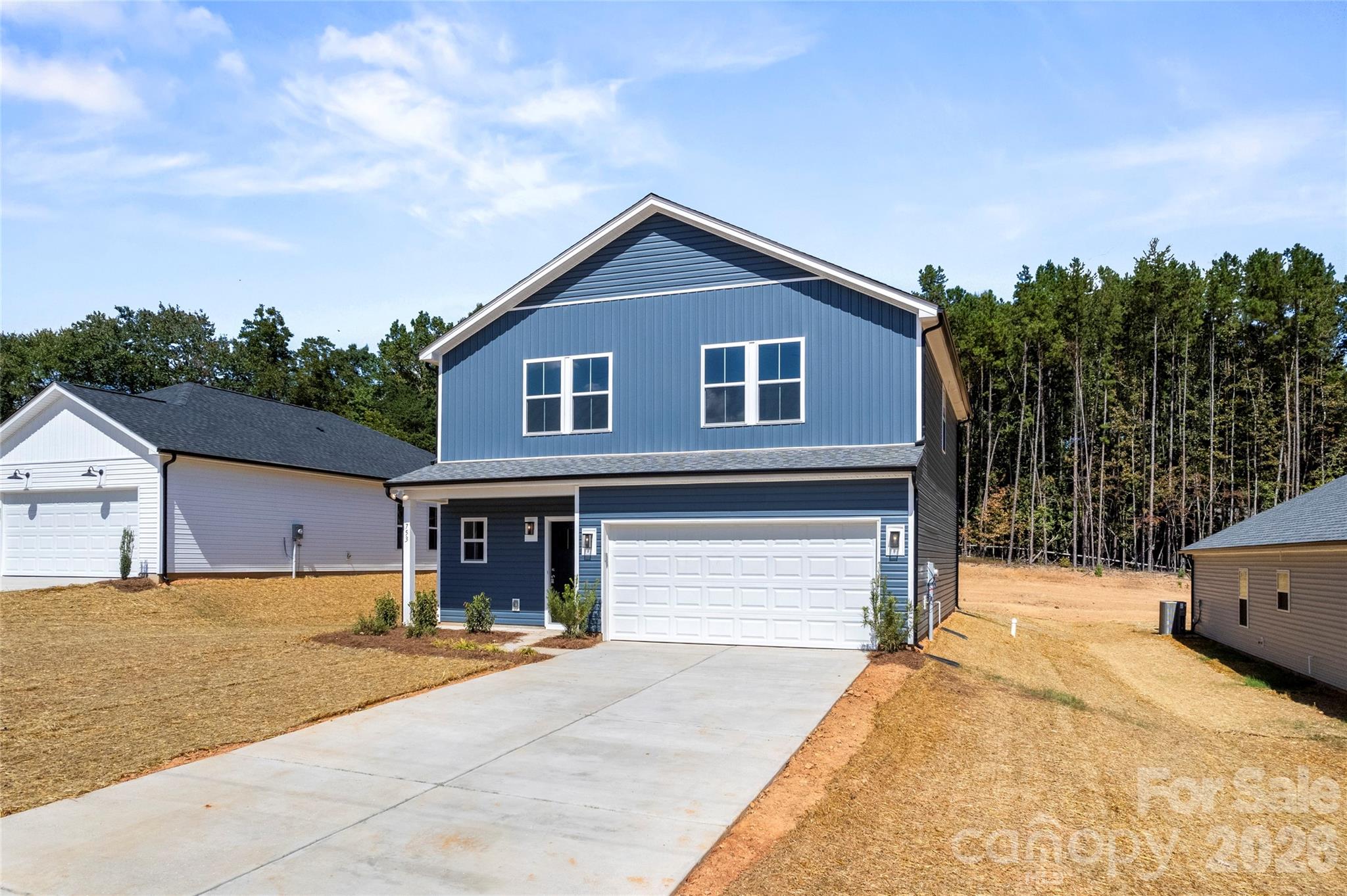 753 Mockingbird Road, Unit 2 Albemarle, NC 28001 - Photo 3 of 36 a front view of a house with yard and garage