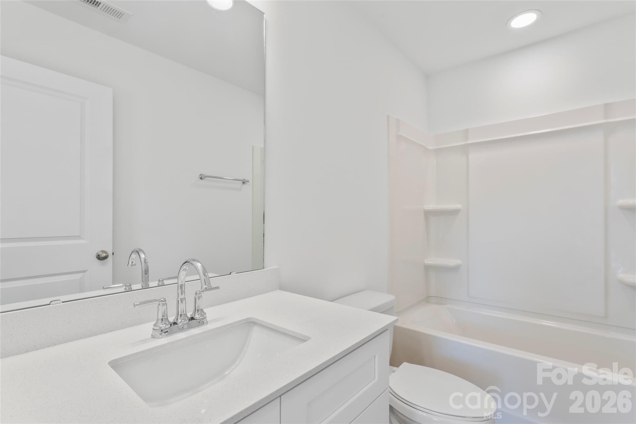 753 Mockingbird Road, Unit 2 Albemarle, NC 28001 - Photo 32 of 36 a bathroom with a sink toilet and a bathtub