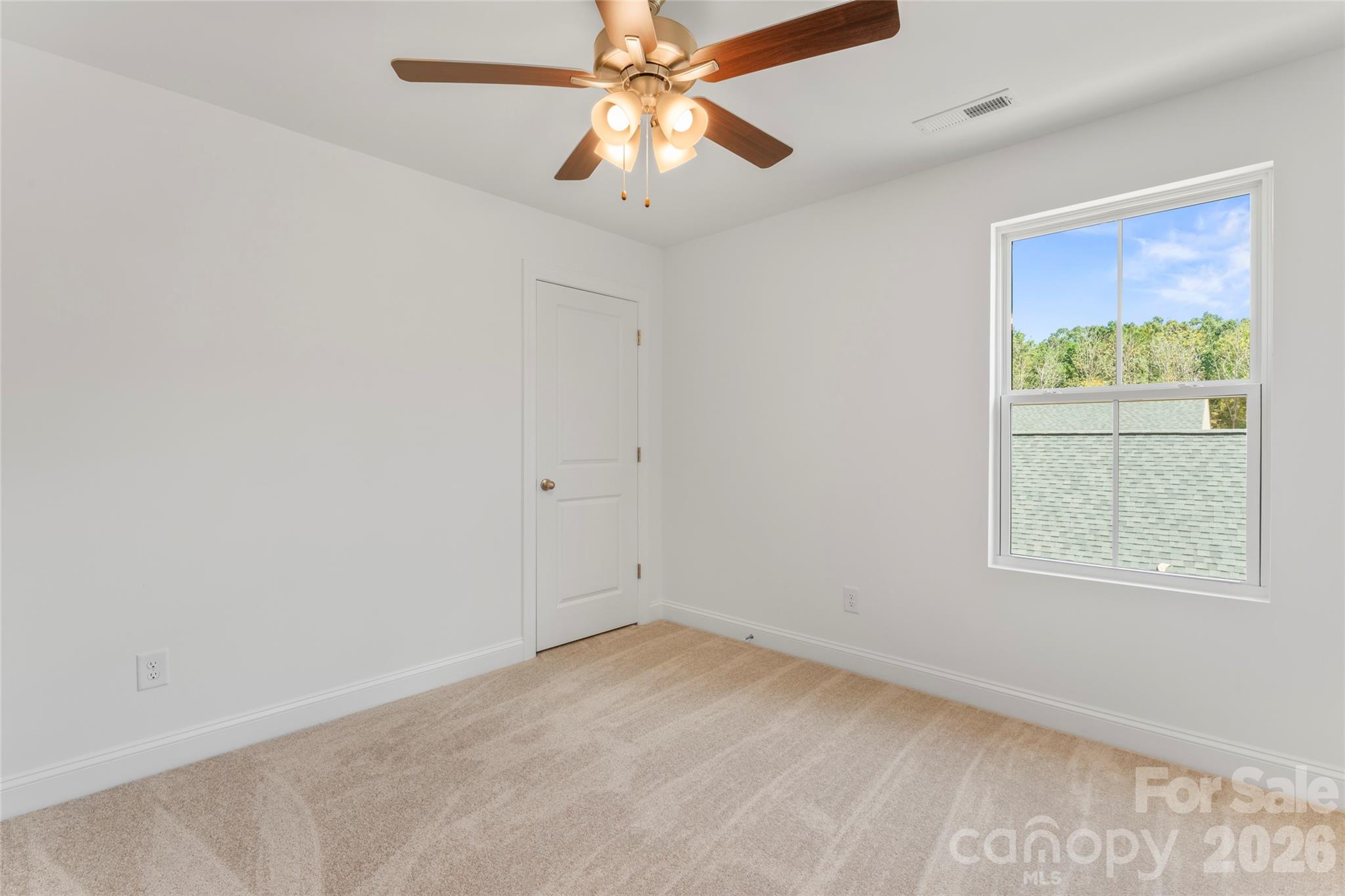 753 Mockingbird Road, Unit 2 Albemarle, NC 28001 - Photo 35 of 36 an empty room with a window and a fan