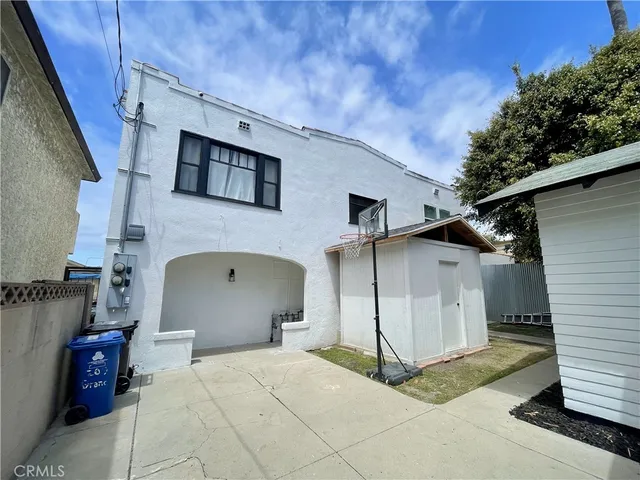 a view of a white house with many windows