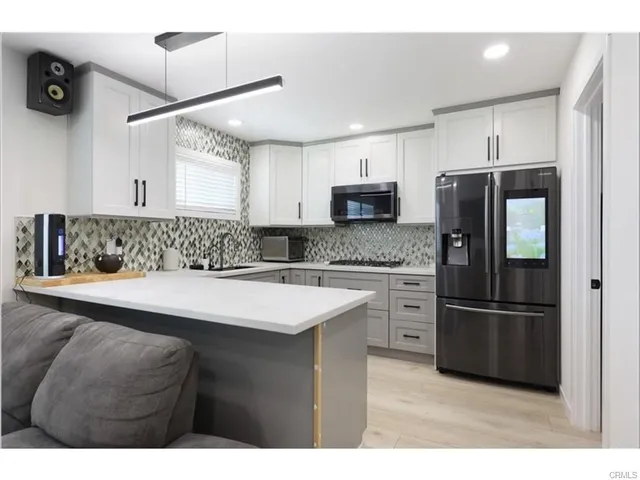 a kitchen with a sink stainless steel appliances and cabinets