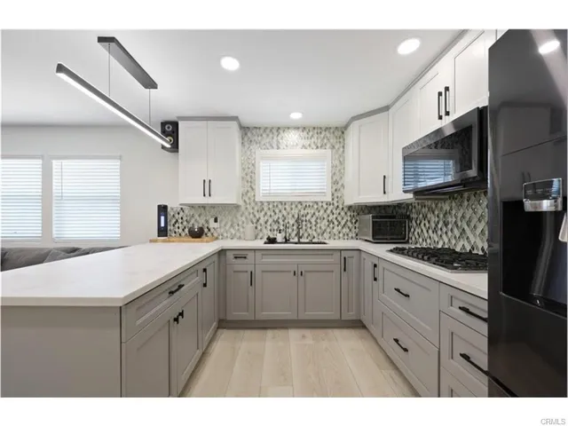 a kitchen with a sink a stove and cabinets