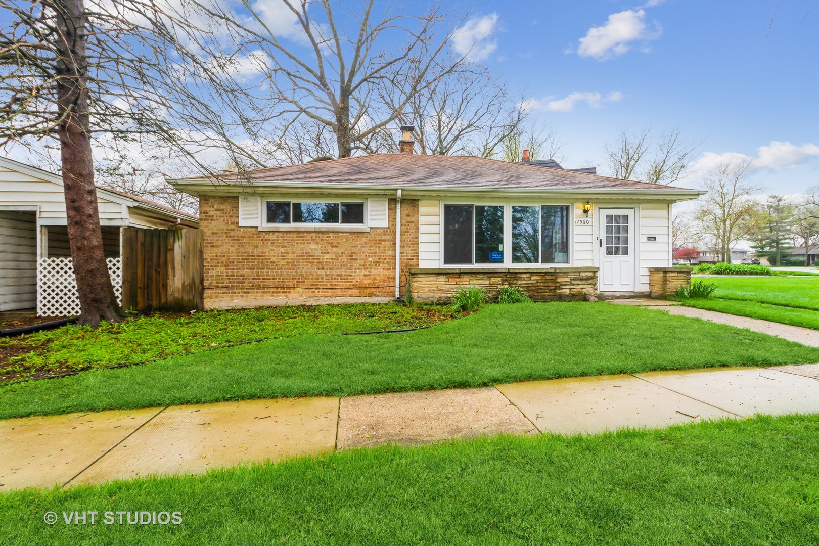 a front view of a house with a garden and yard