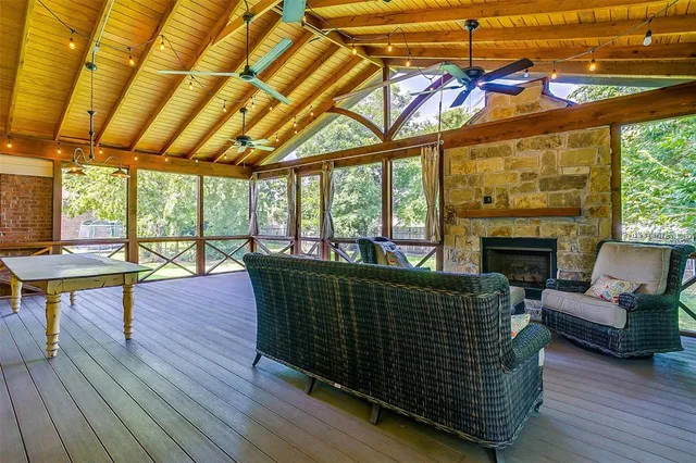 a living room with furniture a wooden floor and a floor to ceiling window
