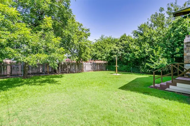 a view of a backyard with a garden and trees