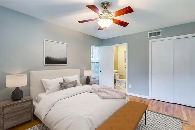 a bedroom with a large bed and a chandelier
