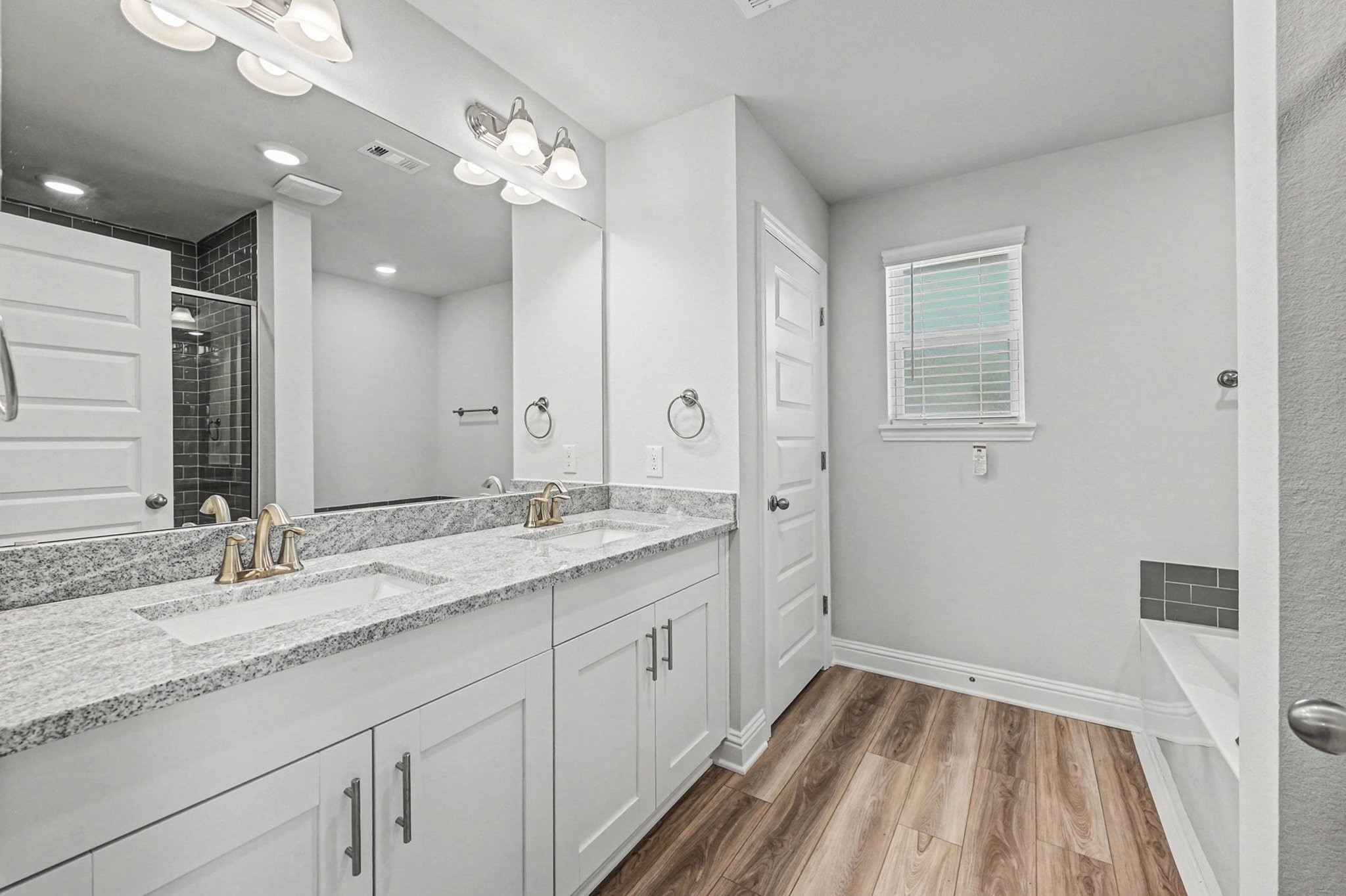 601 Greystone Lane Angleton, TX 77515 - Photo 21 of 32 a bathroom with a sink double vanity granite tub and shower