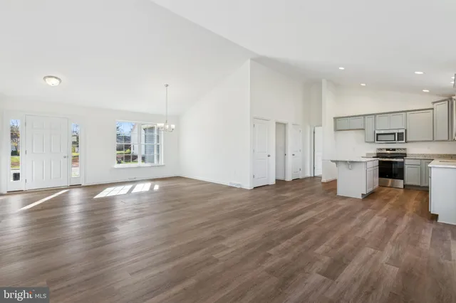 a view of kitchen with wooden floor and electronic appliances