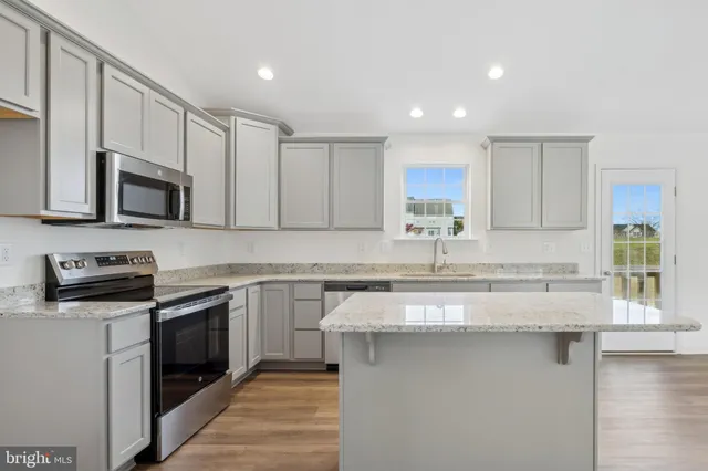 a kitchen with white cabinets and appliances