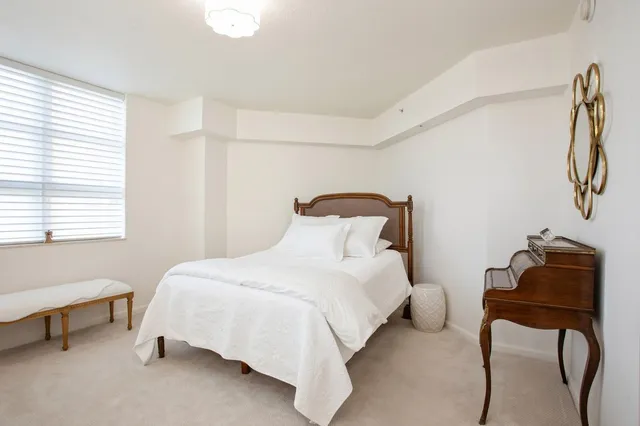 a bedroom with a bed and a chair