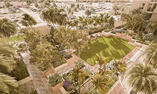 a front view of a multi story residential apartment building with yard and green space