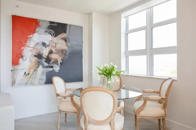 a dining room with furniture and wooden floor