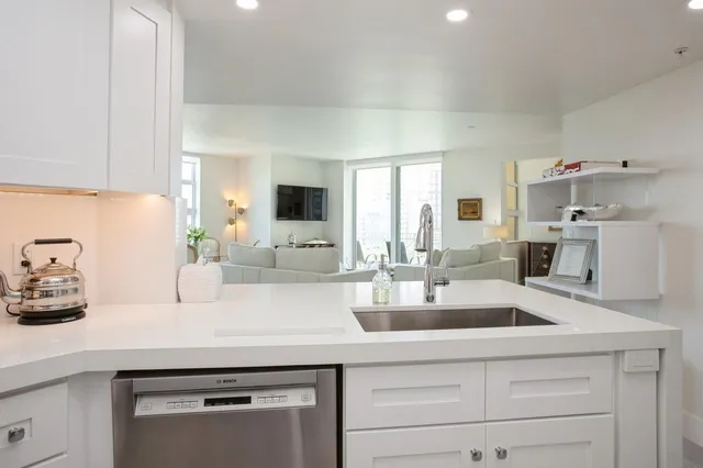 a kitchen with cabinets a sink and wooden floor