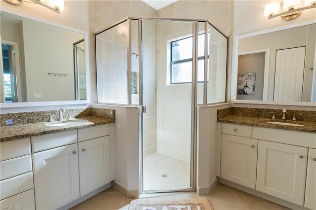 a bathroom with a granite countertop sink mirror and double