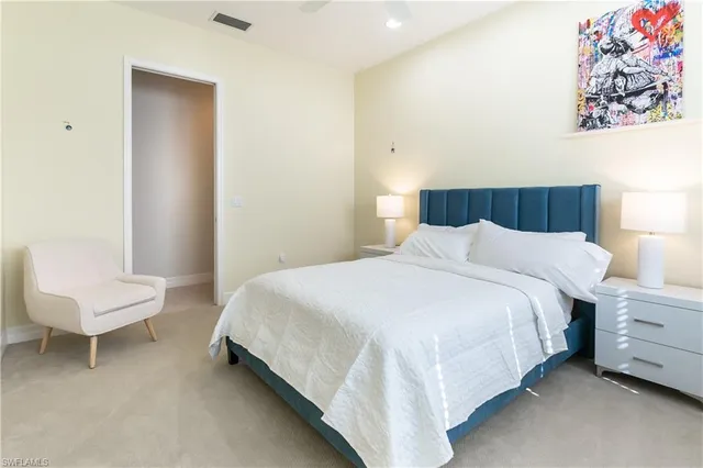 a bedroom with a bed and a chair