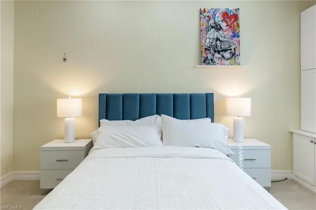 a bed room with a bed and a night stand