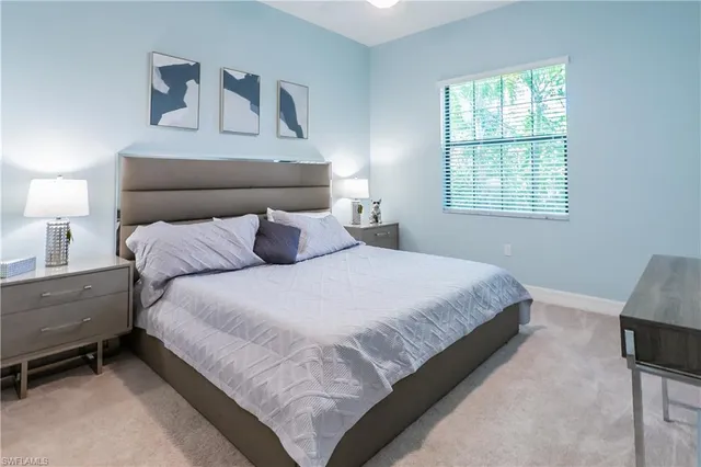 a bedroom with a bed and a lamp