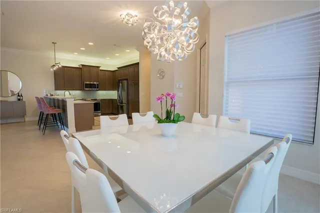 a large white kitchen with a large island