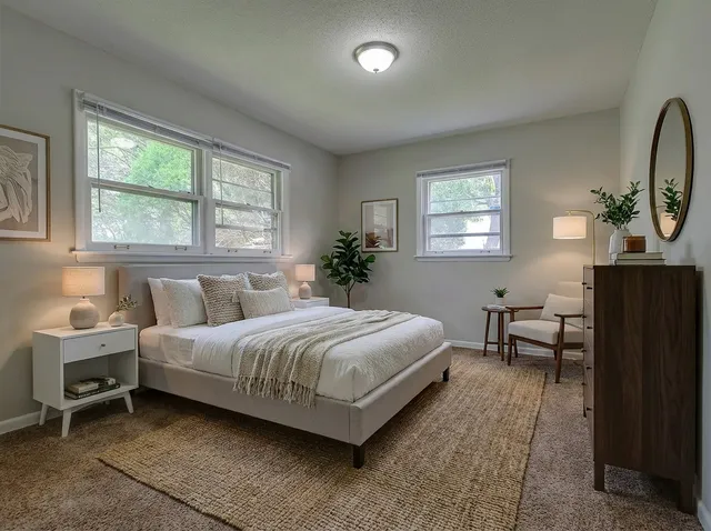 a living room with a bed furniture and a window
