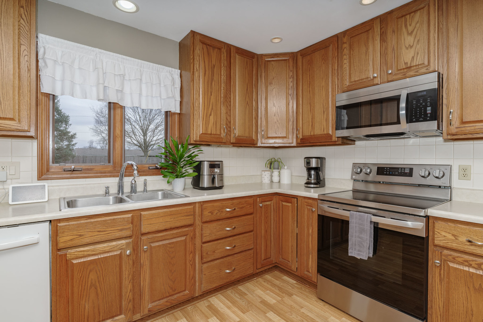 15 Robinwood Drive Normal, IL 61761 - Photo 11 of 35 a kitchen with stainless steel appliances granite countertop a sink a stove a microwave and cabinets