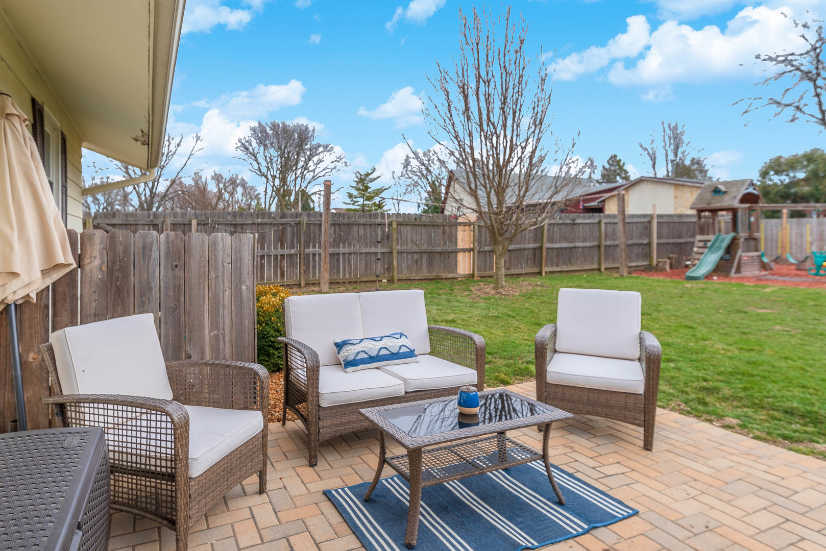15 Robinwood Drive Normal, IL 61761 - Photo 32 of 35 a view of a patio with couches table and chairs with wooden floor and fence