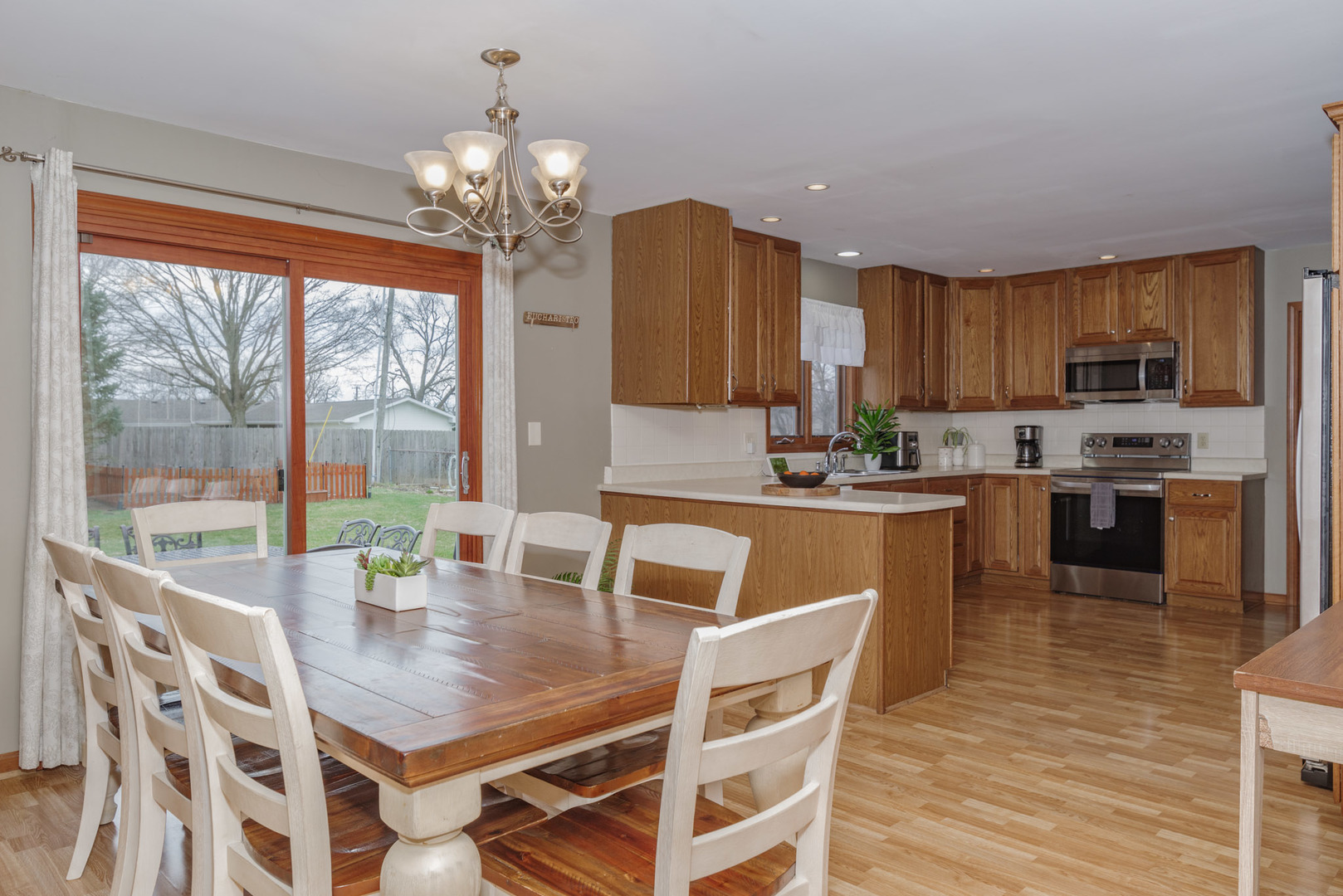 15 Robinwood Drive Normal, IL 61761 - Photo 7 of 35 a kitchen with a dining table chairs and large windows