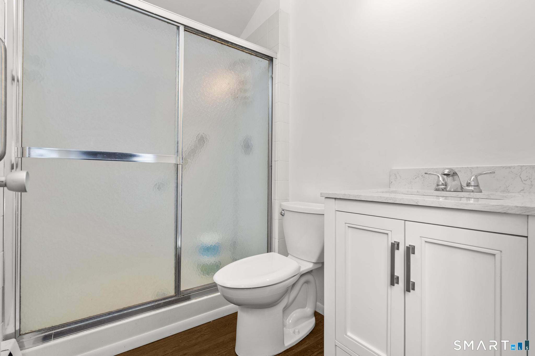 304 Olmstead Hill Road Wilton, CT 06897 - Photo 12 of 35 a bathroom with a sink a toilet and shower