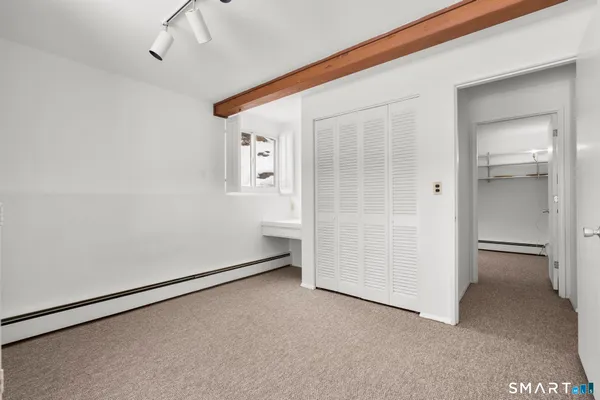 a view of an empty room with a fireplace and a window