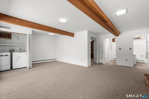 a large kitchen with granite countertop a sink a counter space and stainless steel appliances