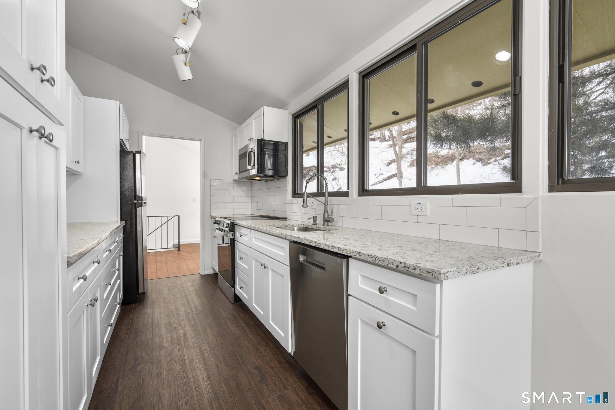 304 Olmstead Hill Road Wilton, CT 06897 - Photo 21 of 35 a kitchen with granite countertop a sink appliances counter top space and stainless steel appliances