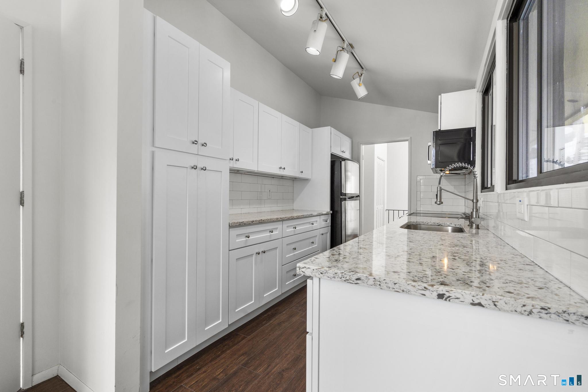 304 Olmstead Hill Road Wilton, CT 06897 - Photo 23 of 35 a kitchen with granite countertop a sink stove and refrigerator